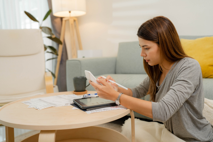 A graduate calculating her college loan repayments.