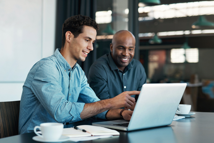 Colleagues review rules for financial advisor website compliance.