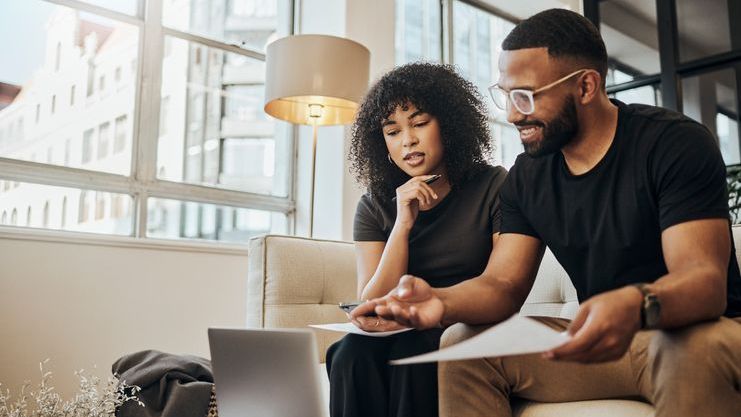 A couple looks over money market account options for their savings.