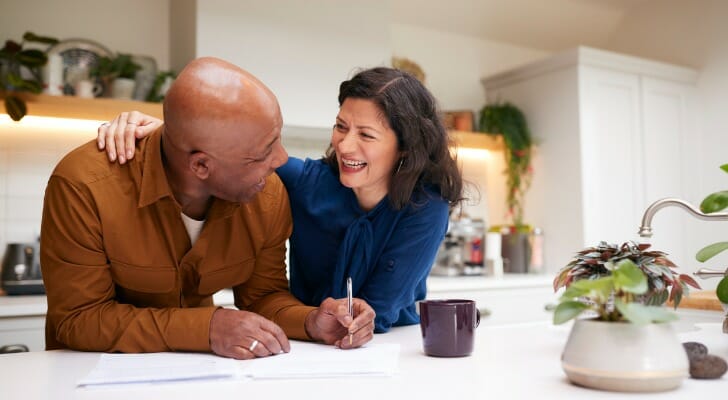 A husband and wife reviewing indexed universal life insurance as a tax-free investment.